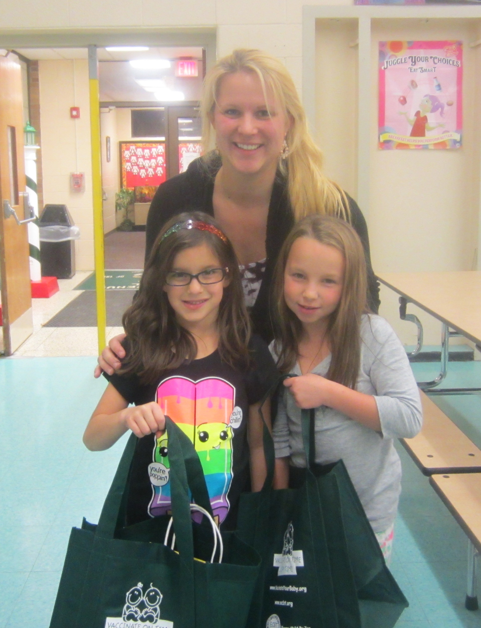 Melody Butler is pictured with two of the Kick the Flu Out of School contest participants.